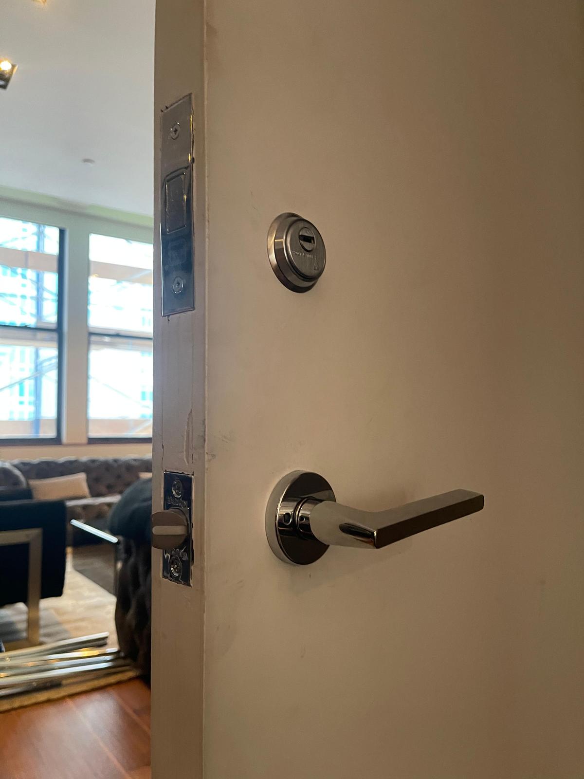 Chrome deadbolt and lever handle NYC apartment
